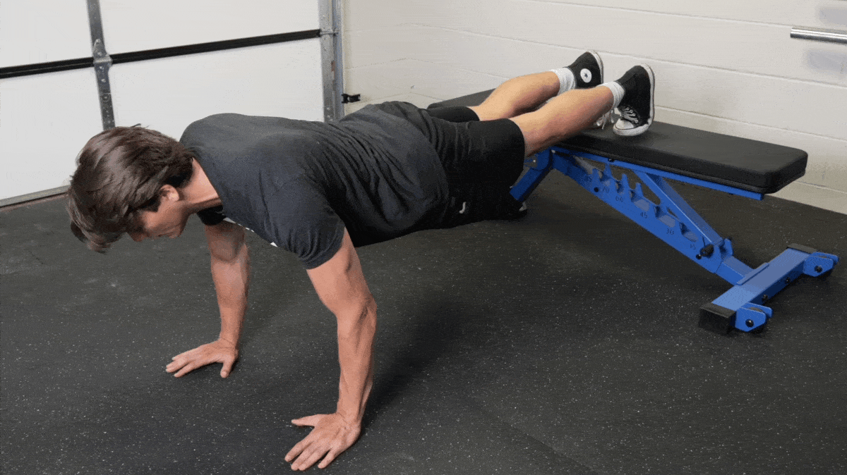 BarBend's Jake Herod performing the decline push-up exercise.
