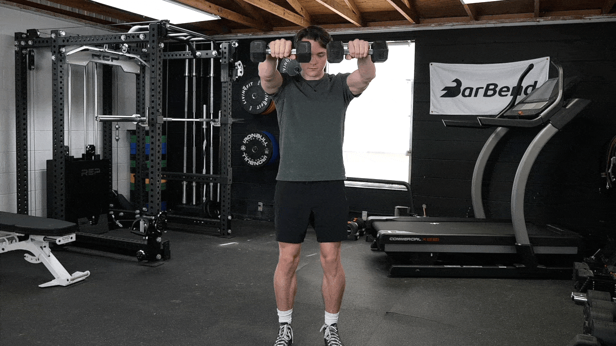 BarBend's Jake Herod performing the dumbbell raise exercise.