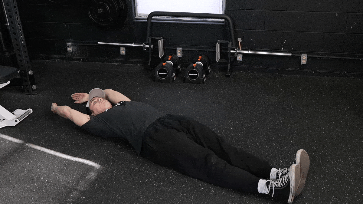 BarBend's Jake Herod performing the hollow hold exercise.