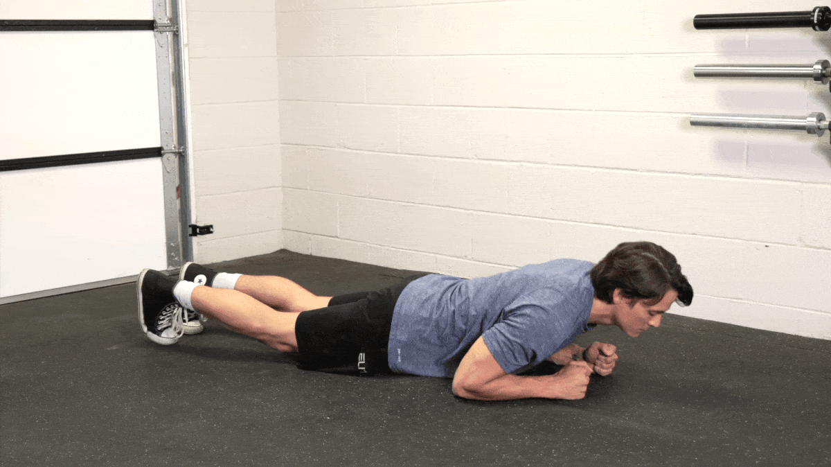BarBend's Jake Herod performing the plank exercise.