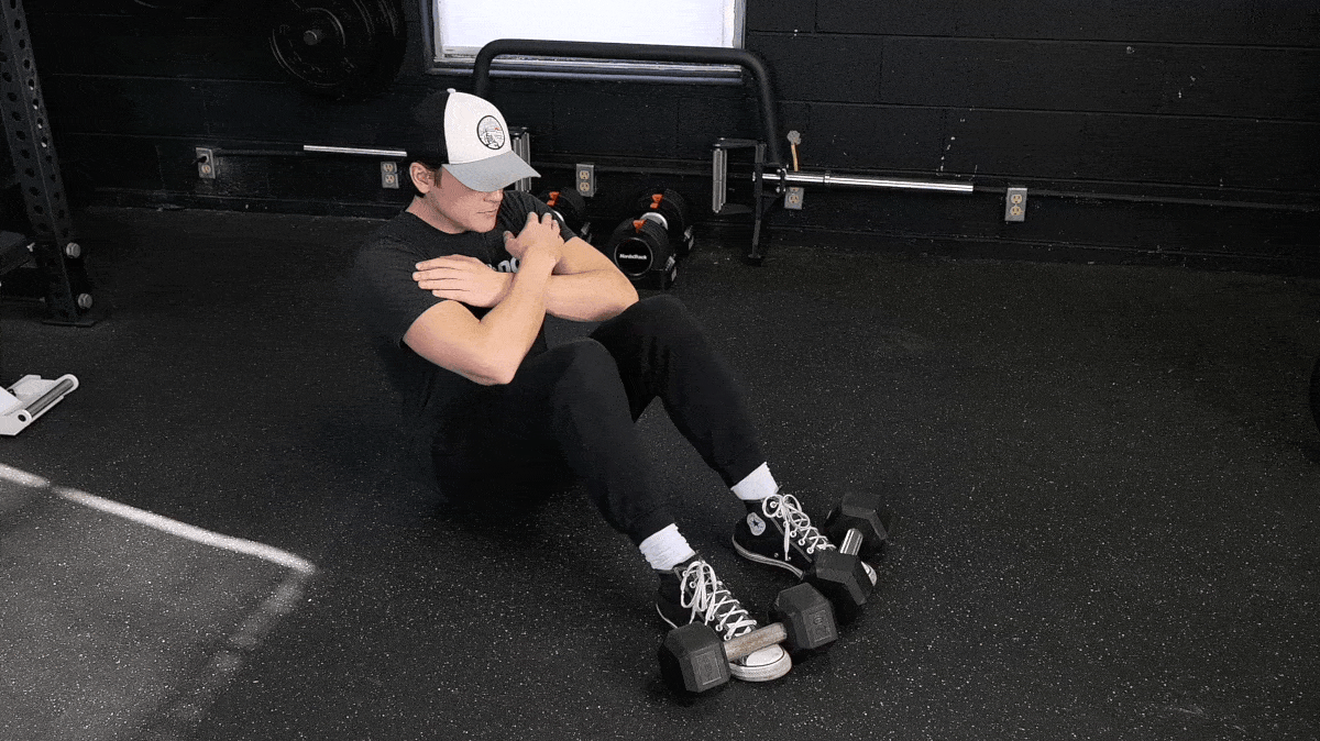 BarBend's Jake Herod doing the bodyweight sit-up.