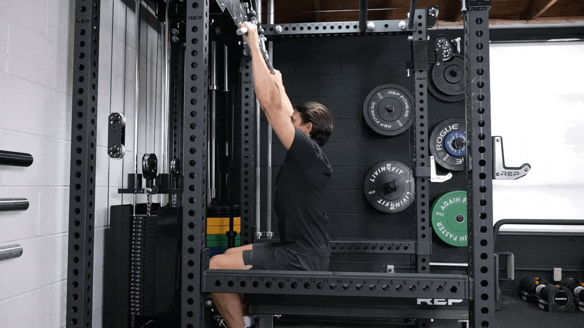 A person performing the Wide-Grip Lat Pulldown.