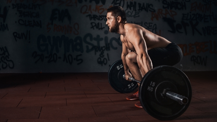 man deadlifting barbell