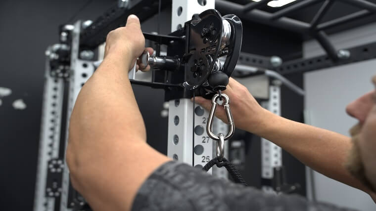 Our tester adjusting the pulley height of the REP Fitness Ares 2.0