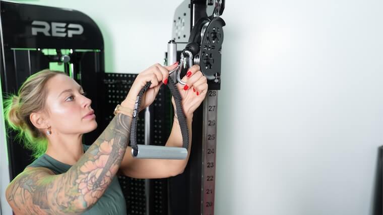 Our tester changing out the attachments on the REP Fitness Arcadia Functional Trainer