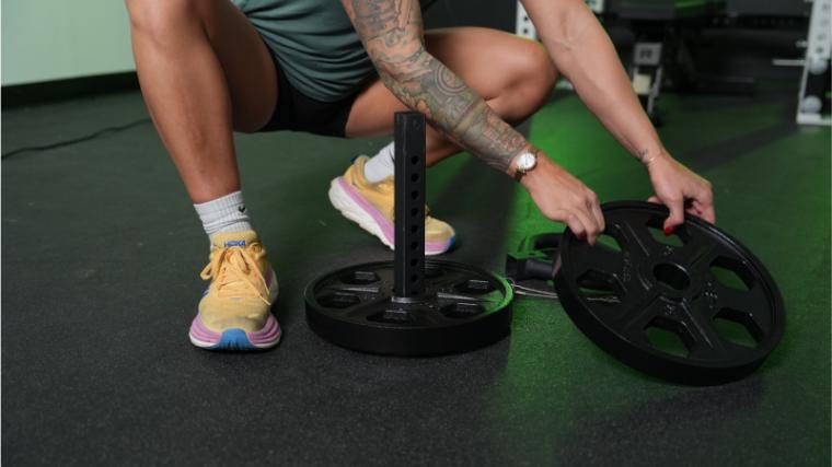 Our tester loading the Titan Fitness Plate Loadable Kettlebell Swing.