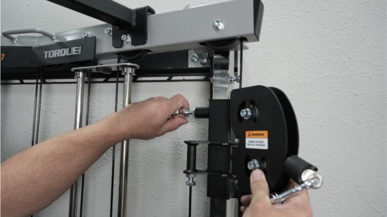 Our tester adjusting the pulley height on the Torque Fitness Anker 7.