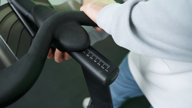 Our tester adjusting the seat of the Echelon Connect EX-5 exercise bike.